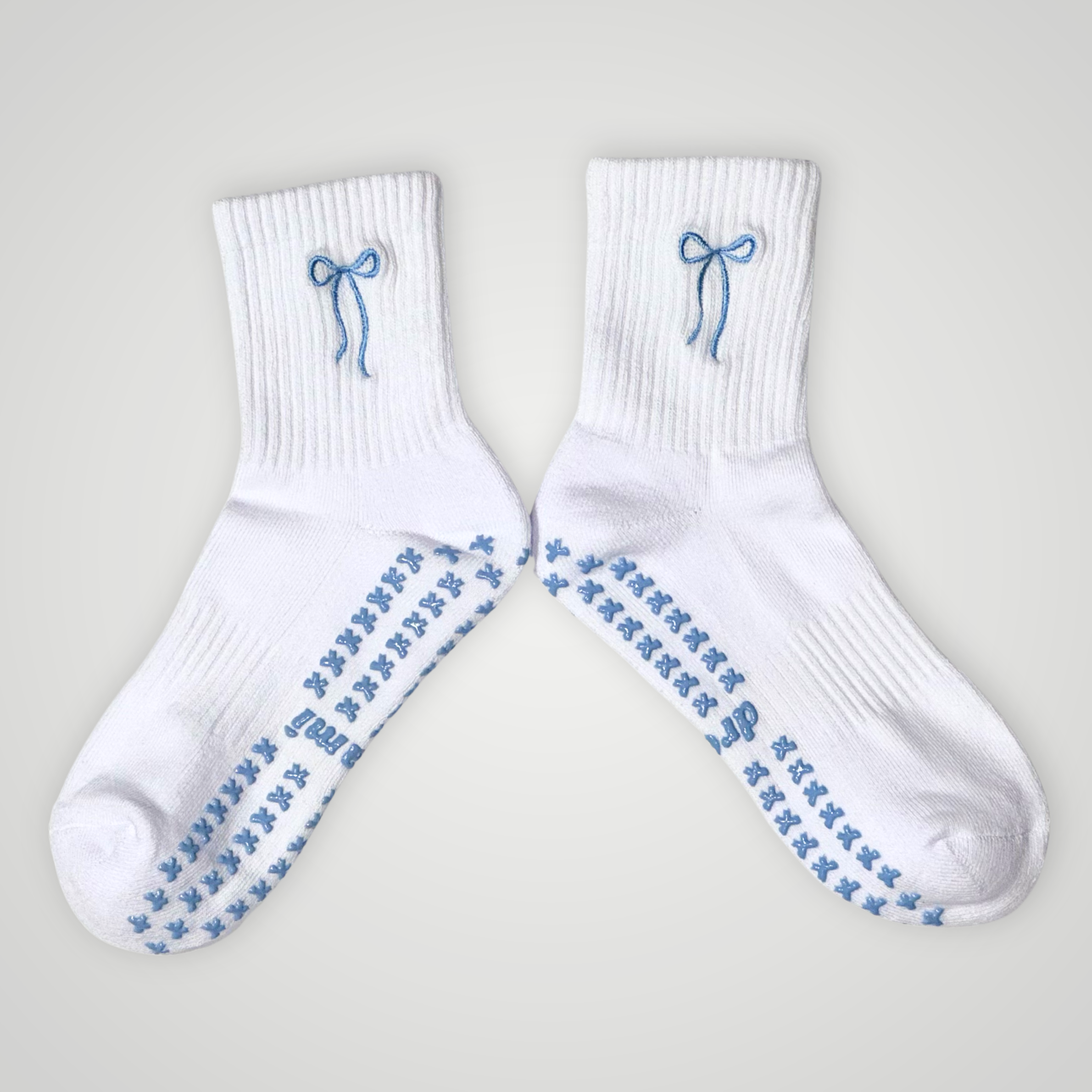 White socks with blue bow design and bow grips