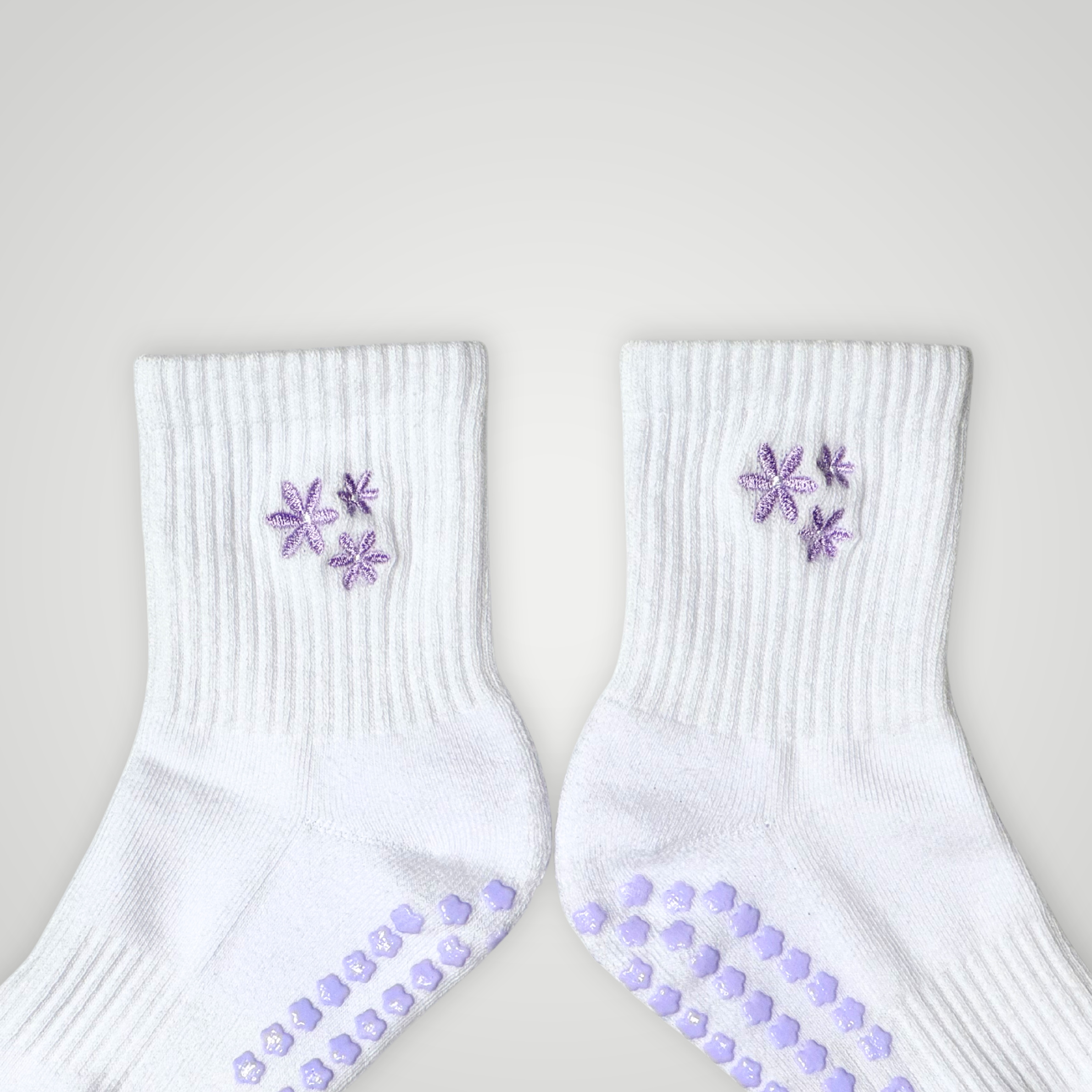 Close up of white socks with purple flower design