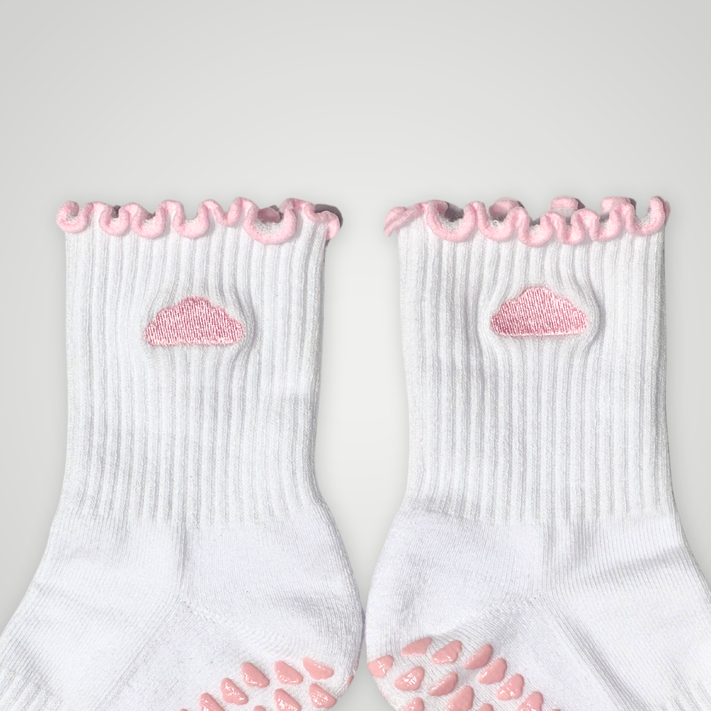 Close up of white socks with pink cloud design