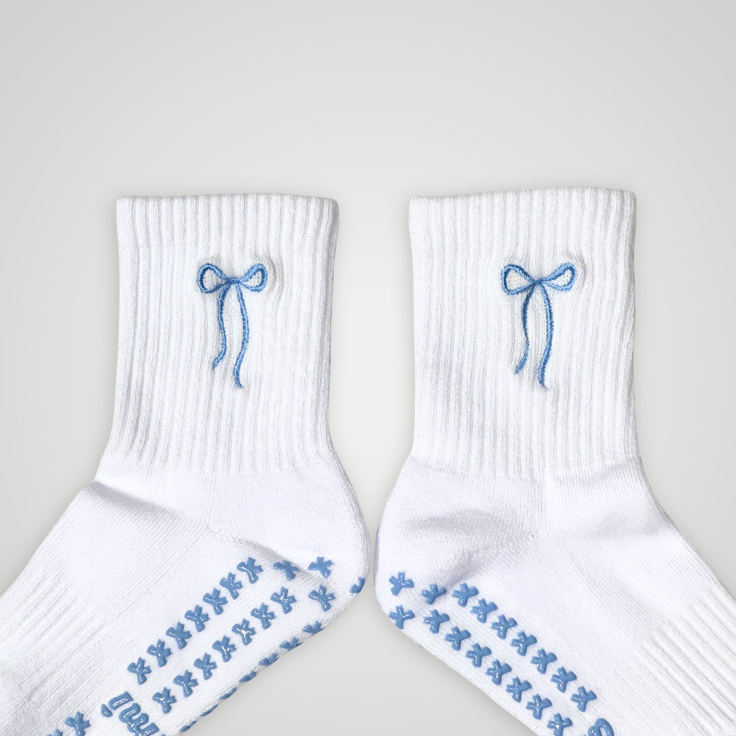 Close up of white socks with blue bow design 