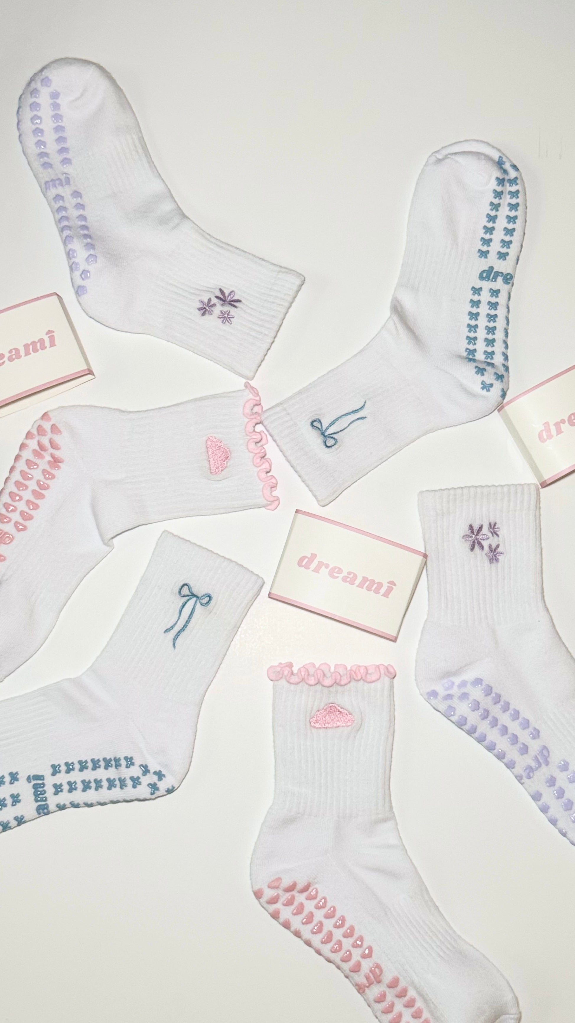 White socks with various designs and 'dreami' text on a light background