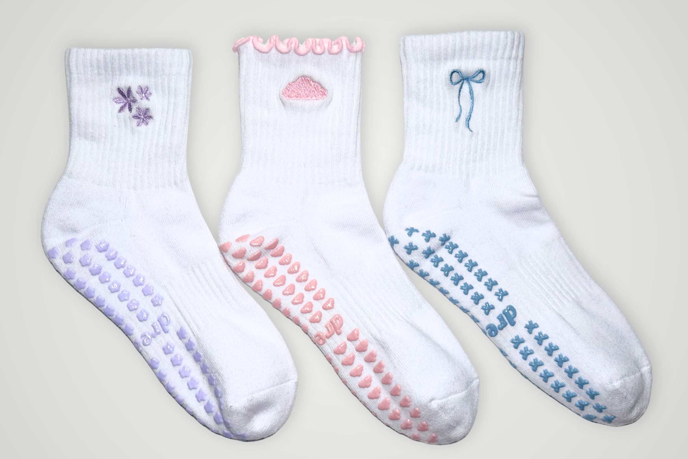 Three pairs of grip socks with different designs