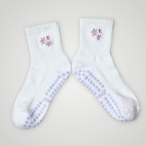 White socks with purple flower design and grips